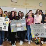 uczniowie z plakatami i żółtymi żonkilami