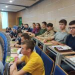 uczniowie siedzący na sali wykładowej