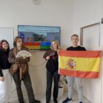 uczniowie trzymający flagę hiszpanii