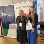 nauczyciele stojący na tle baneru wydarzenia